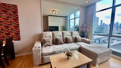 Modern living room with plush sofa and city view from large windows
