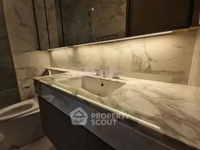 Luxurious marble bathroom with modern fixtures and ambient lighting