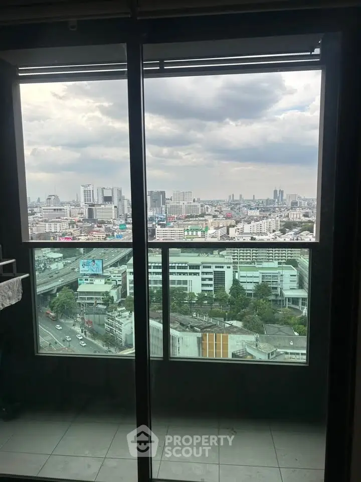 Stunning cityscape view from a high-rise balcony, showcasing urban skyline and expansive horizon.