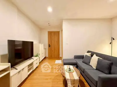 Modern living room with sleek furniture and large TV, perfect for relaxation and entertainment.