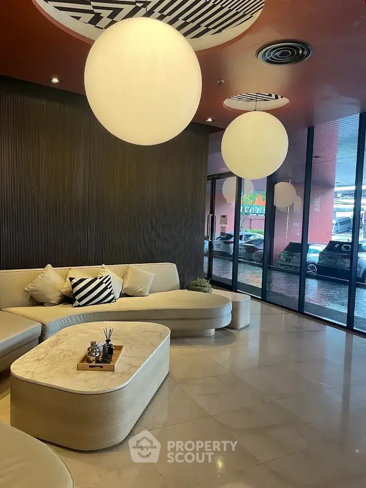Modern lobby with stylish seating and large spherical lights, offering a welcoming ambiance.