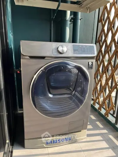 Modern Samsung washing machine on a balcony with stylish lattice design.