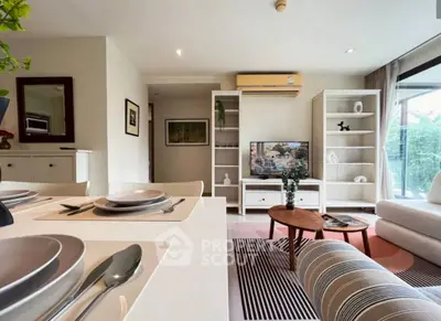 Modern living room with stylish decor and large windows offering natural light.