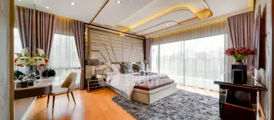Luxurious bedroom with elegant decor and large windows offering natural light.