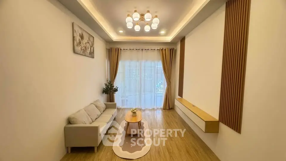 Modern minimalist living room with elegant lighting and cozy seating area.