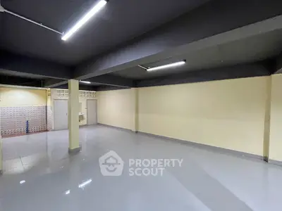 Spacious empty room with modern lighting and glossy flooring, ideal for customization.