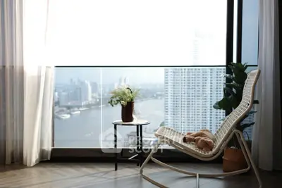 Stunning high-rise balcony with panoramic river and city views, featuring elegant seating and decor.