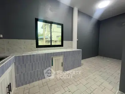 Spacious modern kitchen with sleek design and ample natural light