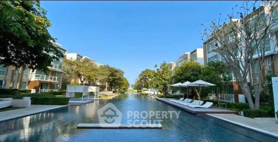 Luxurious residential complex with stunning pool and lush greenery