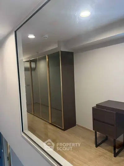 Modern interior with sleek wardrobe and wooden flooring, perfect for stylish living.