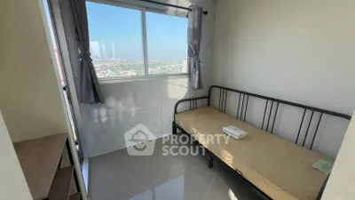 Cozy bedroom with single bed and city view from window