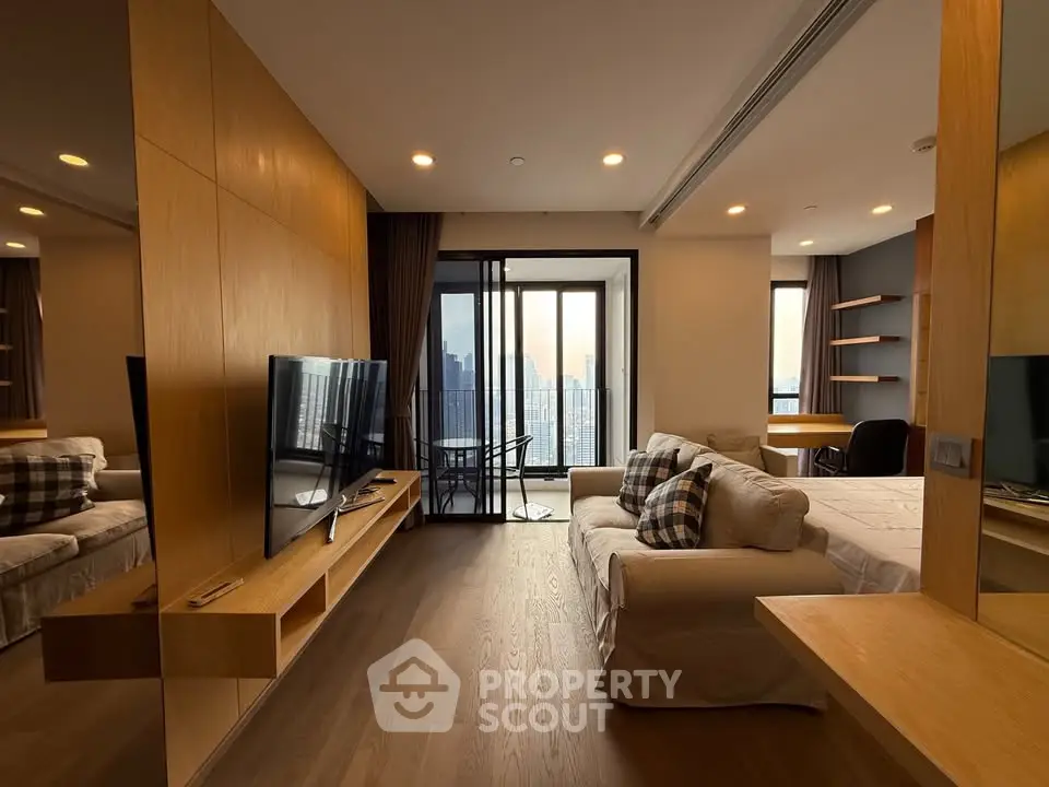 Modern living room with city view, featuring cozy sofa and sleek TV setup, perfect for urban living.