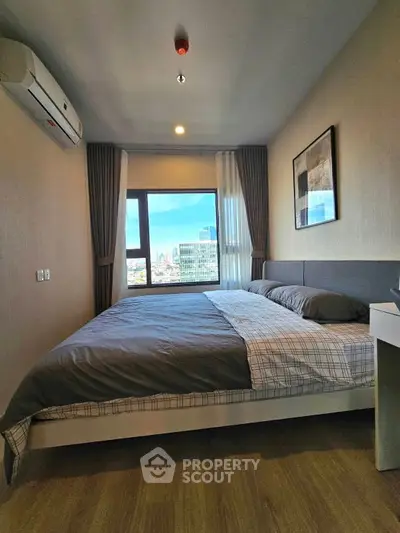 Modern bedroom with city view and stylish decor in high-rise apartment