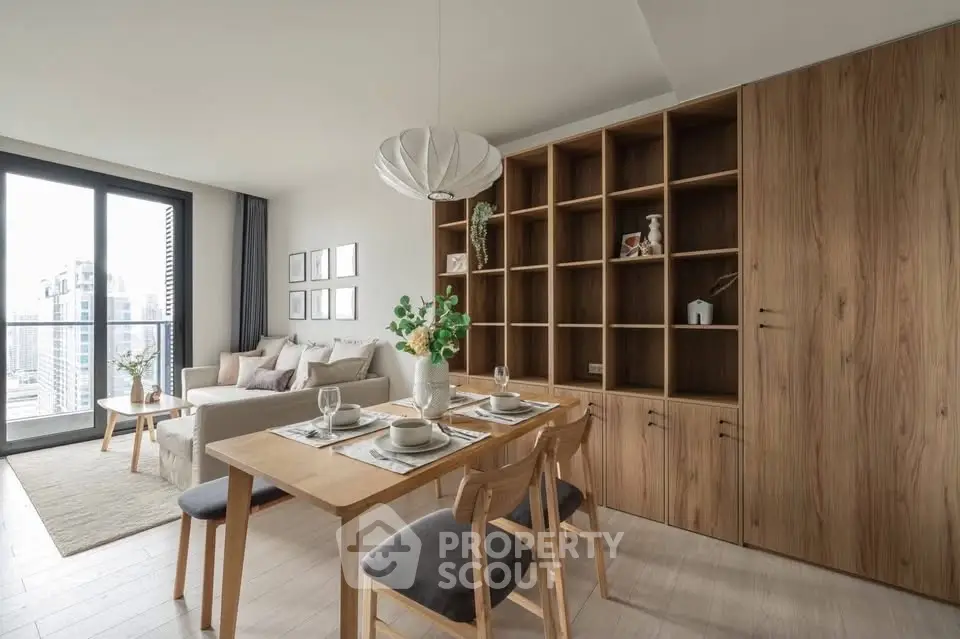 Modern living room with dining area and large windows offering city views.