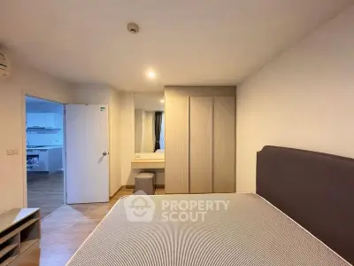 Modern bedroom with sleek wardrobe and cozy atmosphere in a stylish apartment.