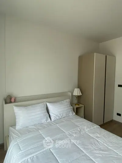 Cozy bedroom with modern wardrobe and elegant lamp, perfect for relaxation.