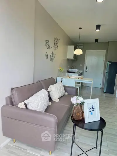 Modern living room with stylish decor and open kitchen layout in a cozy apartment.