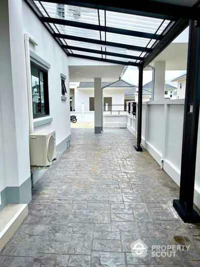 Modern covered walkway with sleek design and natural light