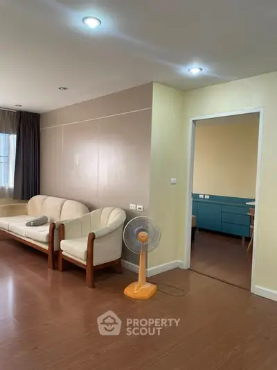 Spacious living room with modern furniture and wooden flooring