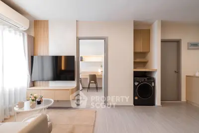 Modern living room with sleek TV setup and cozy study area