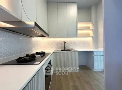 Modern kitchen with sleek cabinetry and gas stove in a stylish apartment