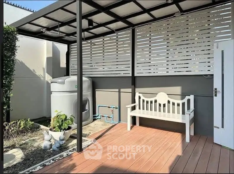 Charming outdoor patio with bench and modern design elements, perfect for relaxation.