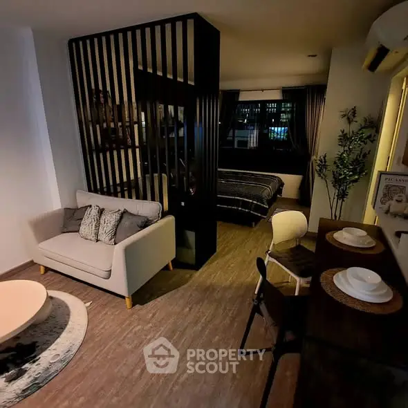 Modern studio apartment with stylish living area and cozy bedroom