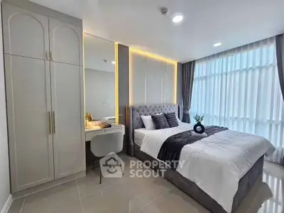 Luxurious modern bedroom with elegant decor and large windows for natural light.