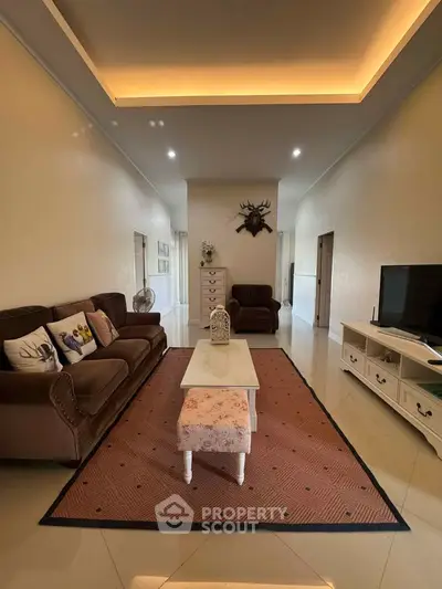 Spacious living room with elegant decor and cozy seating area, perfect for relaxation and entertainment.
