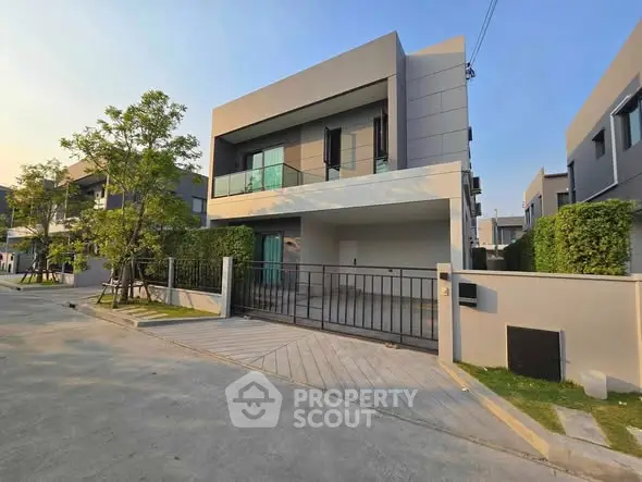 Modern two-story house with sleek design and spacious driveway in a serene neighborhood.