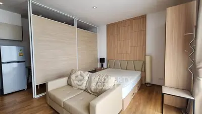 Modern studio apartment with cozy living area and stylish partition