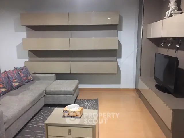 Modern living room with sleek furniture and wall-mounted TV unit