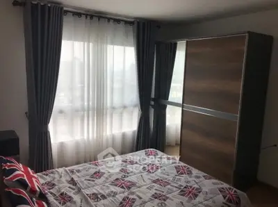 Cozy bedroom with large window and modern wardrobe, featuring stylish curtains and Union Jack bedding.