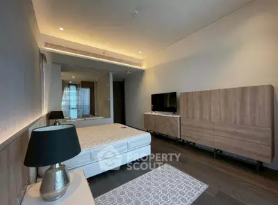 Spacious modern bedroom with sleek furniture and ambient lighting