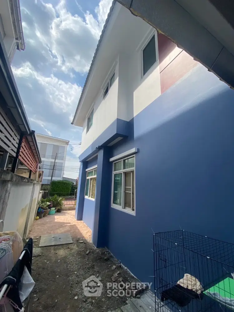 Charming two-story blue house exterior with modern design and ample natural light.