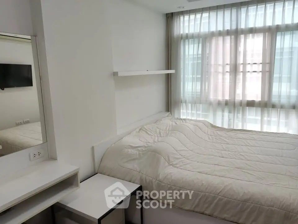 Cozy modern bedroom with large window and minimalist decor