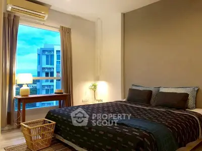 Cozy bedroom with large window and modern decor in urban apartment