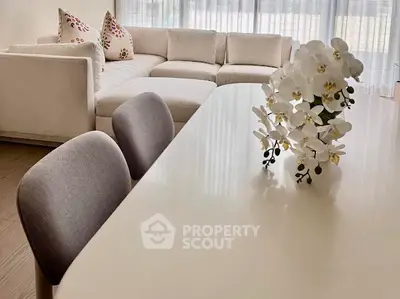 Elegant living room with modern white sofa and stylish dining area