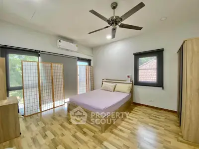 Spacious bedroom with modern decor and natural light