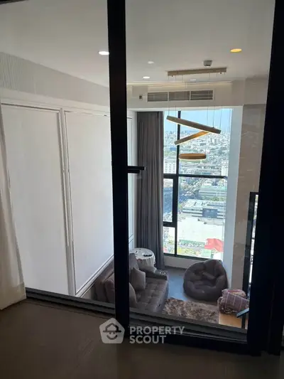 Luxurious high-rise living room with stunning city view and modern decor.