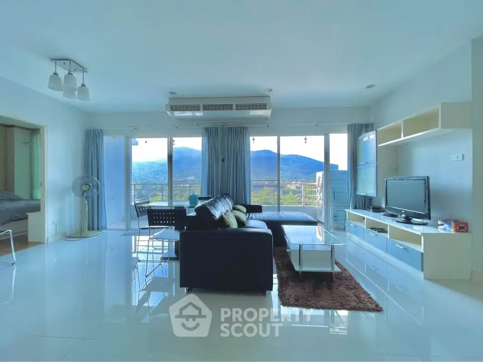 Spacious living room with mountain view and modern furnishings