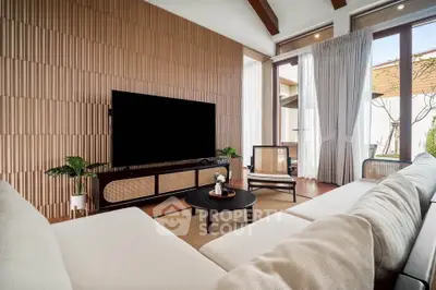 Luxurious living room with modern decor and large TV, featuring elegant wooden accents and natural light.