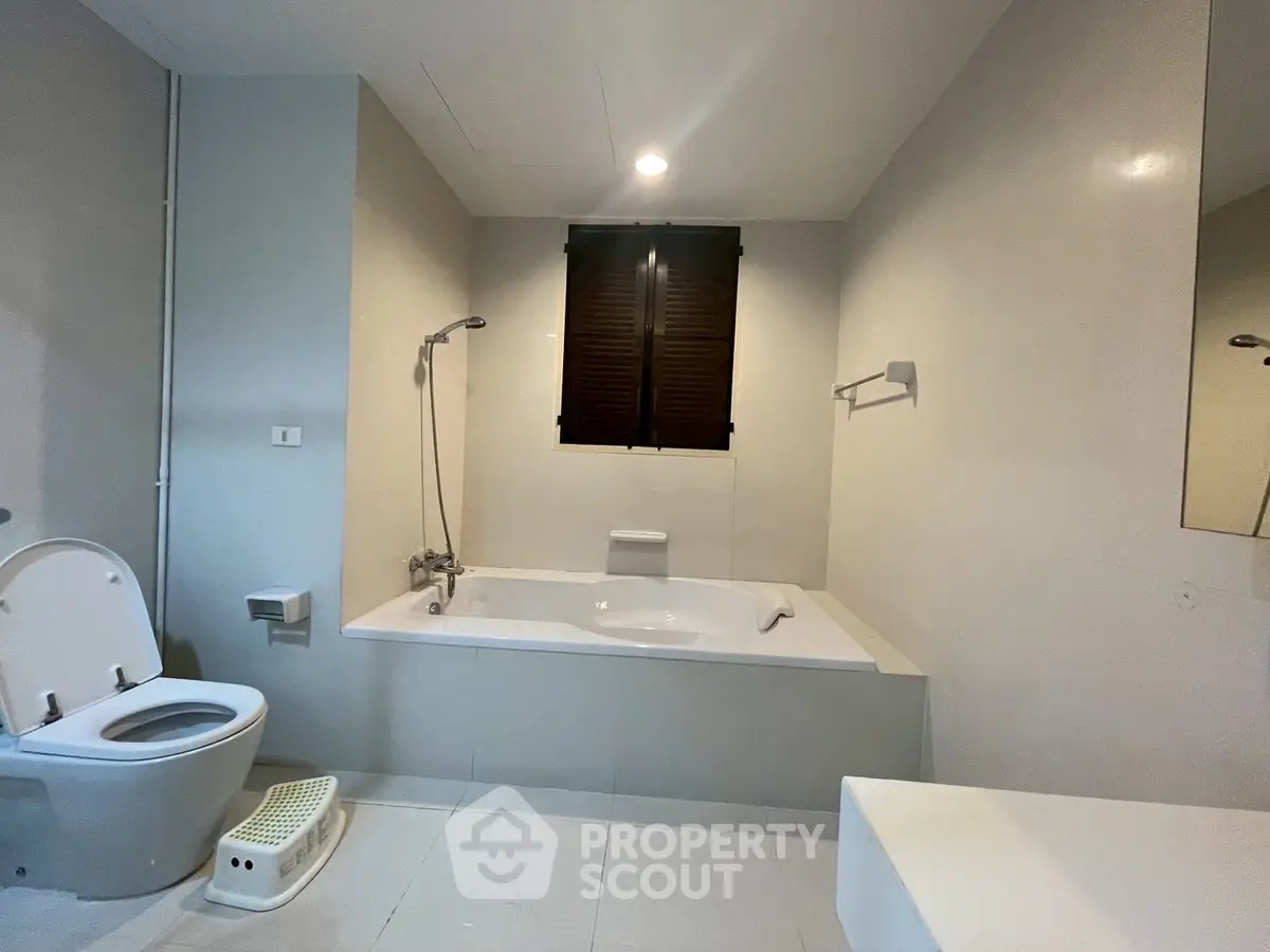 Spacious modern bathroom with bathtub and sleek design