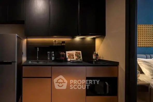Modern kitchen with sleek cabinetry and built-in appliances in a stylish apartment.