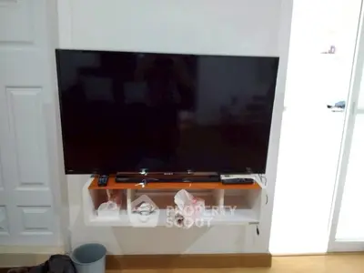 Modern living room with wall-mounted TV and sleek storage unit