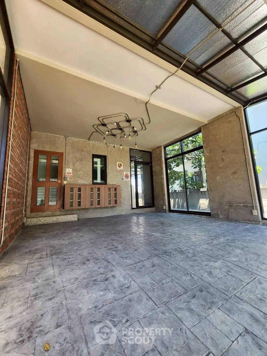 Spacious modern entrance with industrial design and large windows