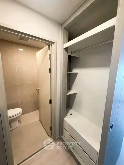 Modern bathroom with adjacent built-in storage in sleek apartment