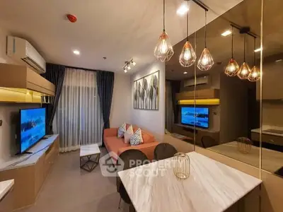 Modern living room with stylish lighting and cozy seating area in a contemporary apartment.