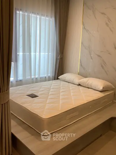 Modern bedroom with elegant platform bed and luxurious curtains