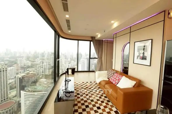 Luxurious corner unit living room with panoramic city view and stylish decor.